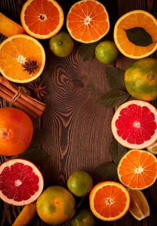 Frame from the citrus assortment, on a wooden table, top view, flat layout, no people, background, toned. ... High quality photoの写真素材