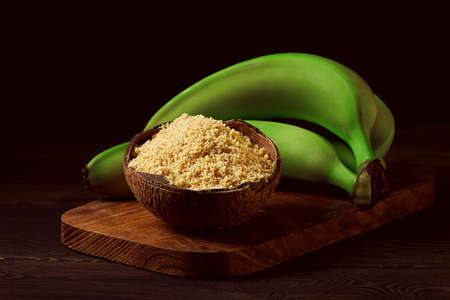 Green banana flour, on a wooden table, healthy food, selective focus, rustic style, horizontal, no people,vegetable flour, gluten-free, platano bananas, green bananas, lifestyle, cooking,の写真素材