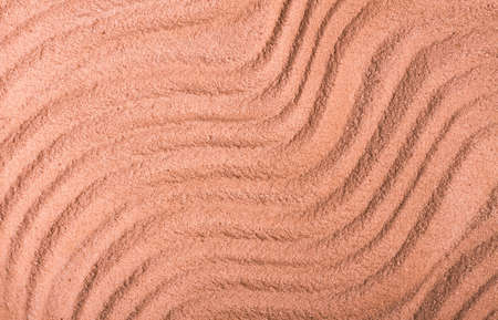 Background with abstract texture ridges on the surface of sand, close-up, top view, coral color, horizontal, without people,の写真素材