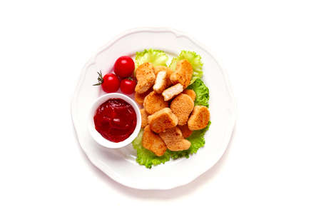 Fried chicken breast nuggets, on lettuce leaves, with tomato sauce, horizontal, no people, selective focus,の写真素材