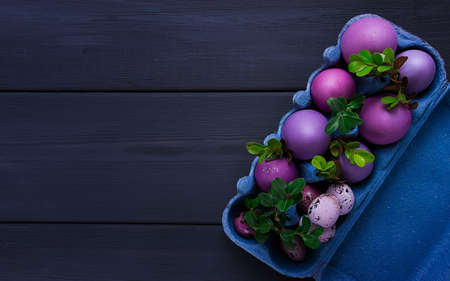 Easter eggs purple and lilac , on a gray wooden table, Easter card, banner, selective focus,...