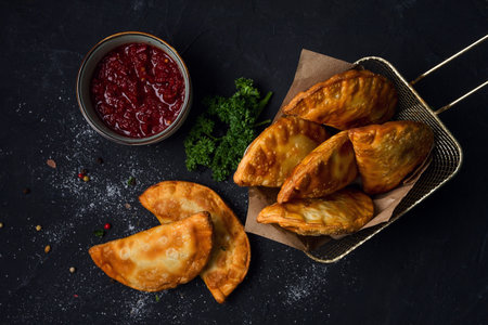 Fried mini pasties with red sauce, top view, close-up, no people, selective focus,の写真素材