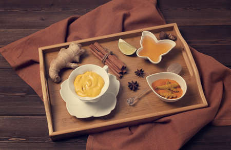 Drink turmeric Latte golden milk with ingredients honey, cinnamon, ginger, curry, top view, horizontal, no people, toned, . high quality photoの写真素材