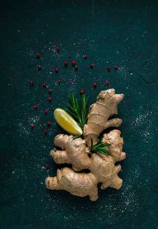 Ginger root food on a dark background, with rosemary, lemon and pepper, concept, food background, no people,の写真素材