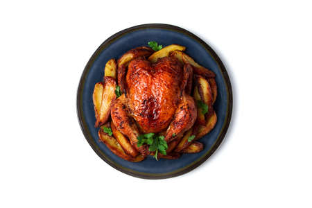 Fried whole chicken with potatoes, on a white background, no people.の写真素材
