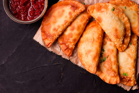 Fried mini pasties with red sauce, top view, close-up, no people, selective focus,