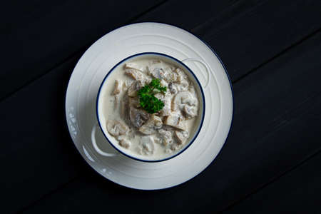 Cream sauce with mushrooms top view, on a dark gray wooden table, horizontal , no people,の写真素材