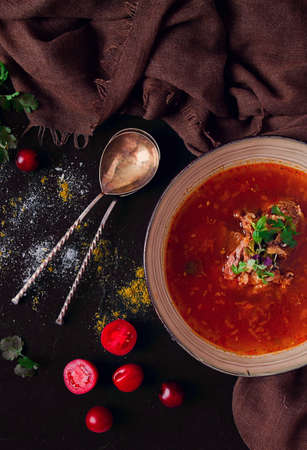 Traditional Georgian dish spicy tomato , Kharcho soup, on a dark background, no people, top view,