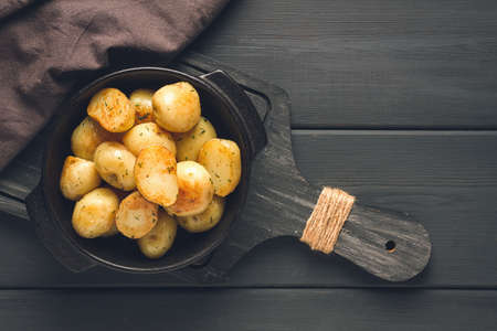 Fresh Cooked new potatoes,with dill, on a wooden table, selective focus. close-up, toning, no people,の写真素材