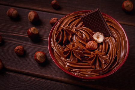 Chocolate nut paste mousse pasta, in a cup, on a wooden table, top view, selective focus, no people,の写真素材