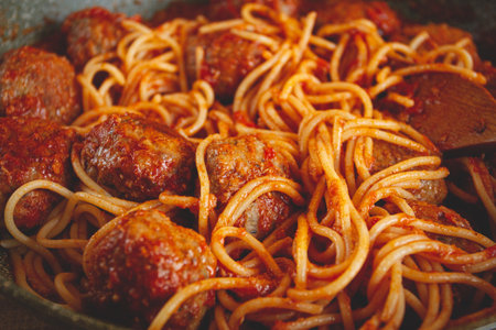 spaghetti with meatballs, in tomato sauce, cooking in a frying pan, no people, homemade,の写真素材