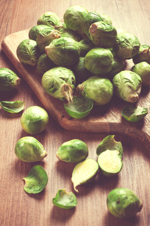 fresh Brussels sprouts, raw, top view, on a wooden table, no people,の写真素材