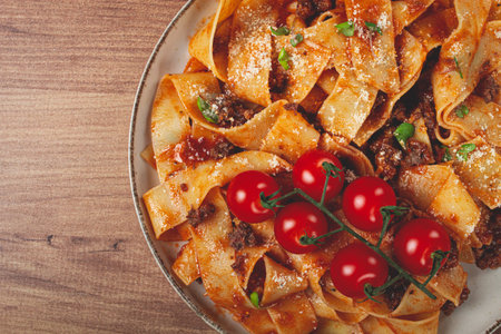 pappardelle pasta with bolognese sauce, topped with parmesan cheese, homemade, no people,の写真素材