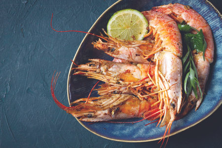 Langoustines, Australian, freshly frozen on ice, top view, lime and greens,の写真素材