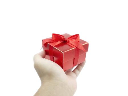 Hand holding red gift box on white backgroundの写真素材
