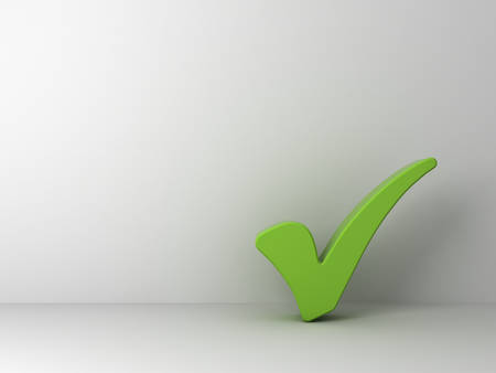 Green check mark on empty white wall backgroundの写真素材