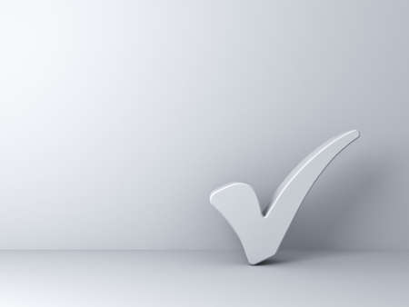 White check mark on empty white wall backgroundの写真素材