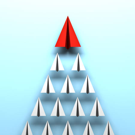 Red paper plane leads white paper planes on blue background leadership conceptの写真素材