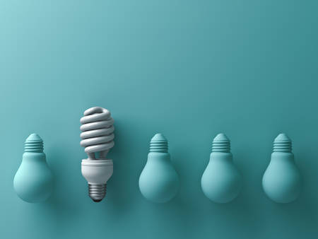 One eco energy saving light bulb different and stand out from old incandescent lightbulbs on green background with shade and shadow , individuality and different creative idea concept . 3D rendering.の写真素材