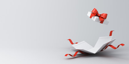 Open white present box or gift box with red ribbons and bow isolated on white grey background with...