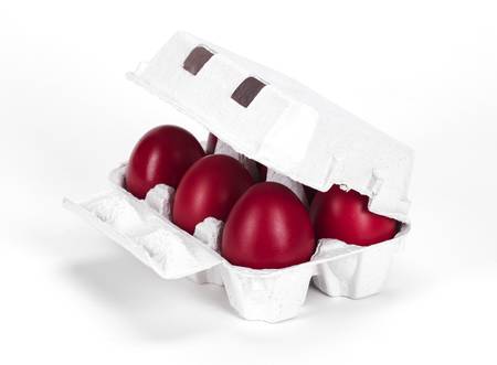 six red boiled eggs in a protective paper boxの写真素材