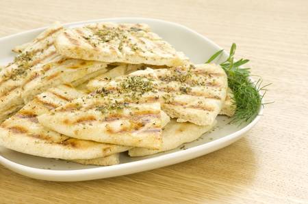 greek grilled pittas sliced and poured with olive oil and oregano