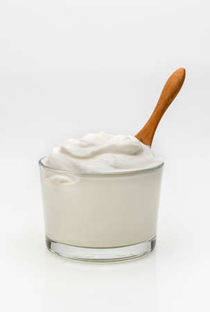 a bowl of greek yogurt on a white backgroundの写真素材