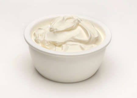 a bowl of greek yogurt on a white backgroundの写真素材