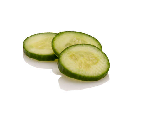 fresh cucumber slices isolated on a white backgroundの写真素材