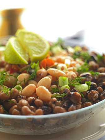 a traditional greek plate made of two kinds of beans,green onion,tomato,dill and olive oil.It is...