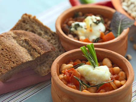 beans,baked in two different ways,in ceramic bowls and decorated with a brass traditional bowl full of a variety of beansの写真素材