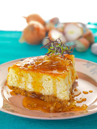a cheese cake made of eggs, goat cheese on a roasted bread base, served with an onion marmeladeの写真素材