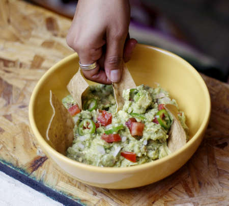 A plate of fresh guacamole with corn tortilla.の写真素材