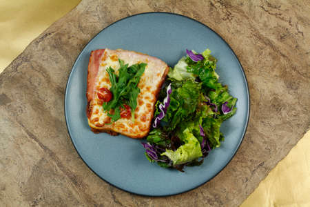 Delicious croque French breakfast with ham, cheese and lettuce.のeditorial素材