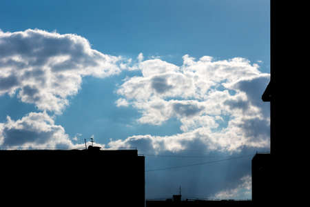 White clouds slowly float across the blue skyの写真素材