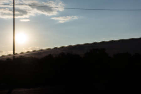 White clouds slowly float across the blue skyの写真素材