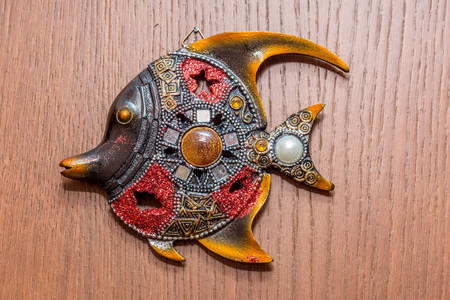 Figurine of fish hanging on the wallの写真素材