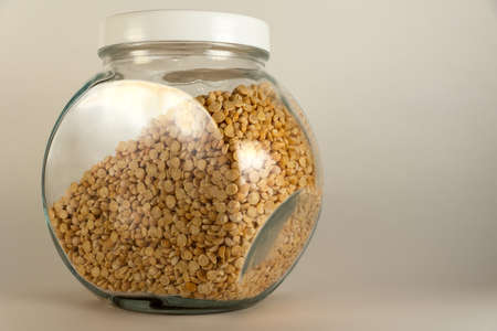 Dried peas broken up closeup on a white backgroundの写真素材