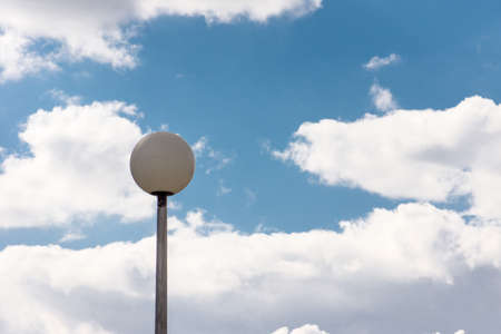 White clouds slowly float across the blue skyの写真素材