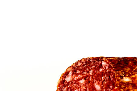 A piece of smoked sausage on a white background