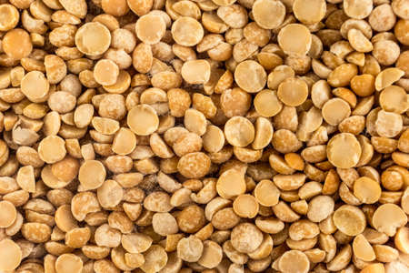 Dried peas broken up closeup on a white backgroundの写真素材