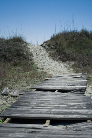 Old broken boardwalk to the beachの写真素材