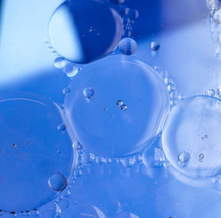 Abstract bubbles background in blue colorの写真素材