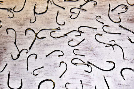 picture on white background full of fishing hooksの写真素材