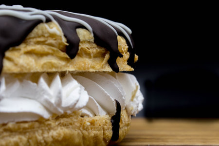 A crown-shaped cake containing layers of puff creme and chocolate, with icing sugarの写真素材