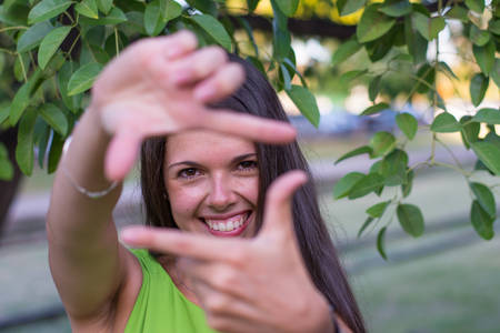 Woman portrait outdoors with green shirt in summer