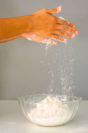 Women's hands preparing flour for baking bread