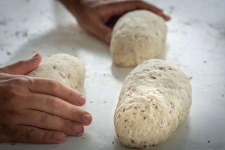 Man kneading a large dough for homemade bread in quarantine