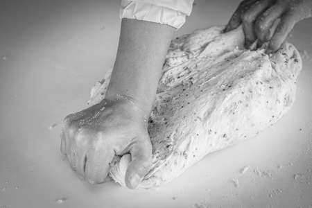 Man kneading a large dough for homemade bread in quarantineの写真素材