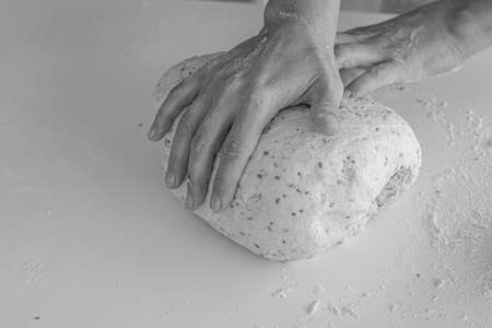 Man kneading a large dough for homemade bread in quarantineの写真素材